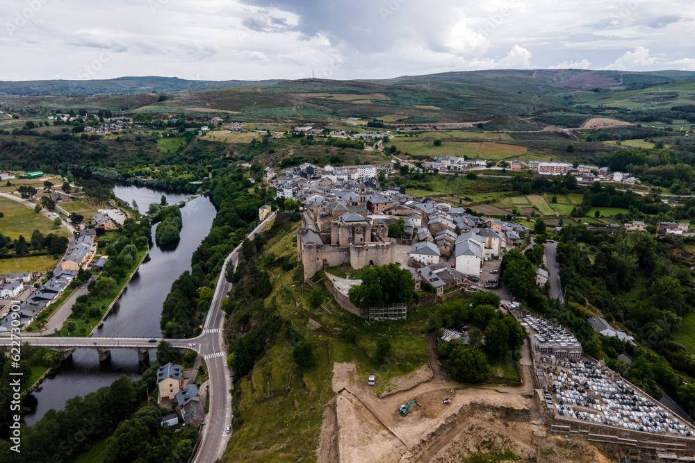 Aerial view of Puebla de Sanabria, a small town with a medieval castle along the Rio Tera river in Zamora, Spain. Aerial view of Puebla de Sanabria, a small town with a medieval castle along the Rio Tera river in Zamora, Spain.