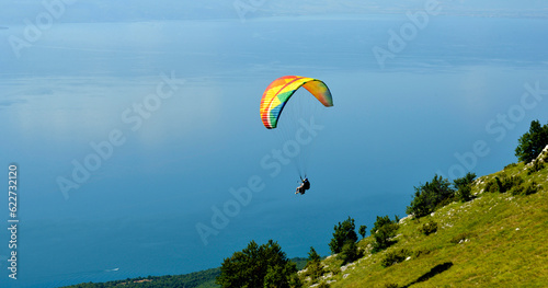 Tandem Paraglider flying over the Lake Ohrid in soutwest of macedonia