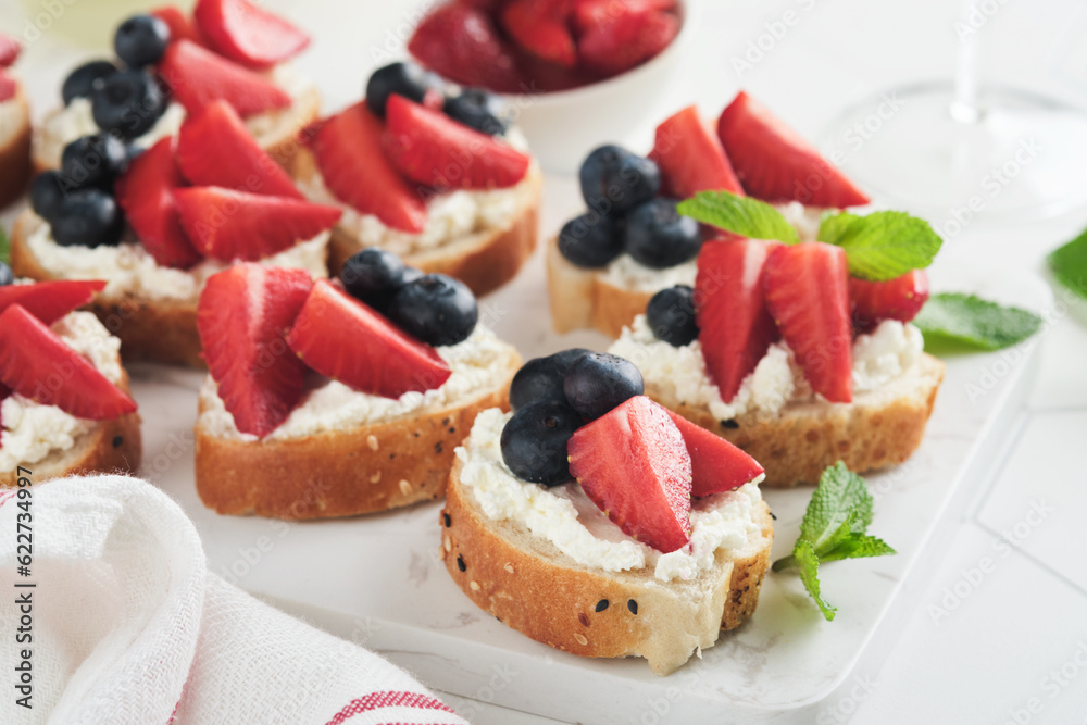 American flag sandwich with strawberries, blueberries, whipped sweet cream, soft cheese on toast bread. 4th of July American Independence Day food. Independence or Patriotic Day breakfast idea Mock up