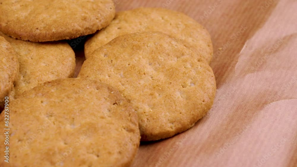 High calorie sweet biscuits on a wrapping paper. Baked wheat cookies. Junk food. Macro shot. Rotation High calorie sweet biscuits on a wrapping paper. Baked wheat cookies. Junk food. Macro shot. Rotation