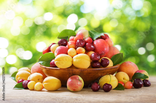 bowl of fresh ripe fruits on a wooden table