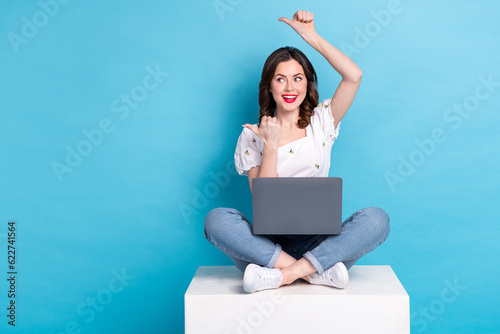 Full length photo of pretty tricky girl dressed white top working modern device two thumbs empty space isolated blue color background © deagreez