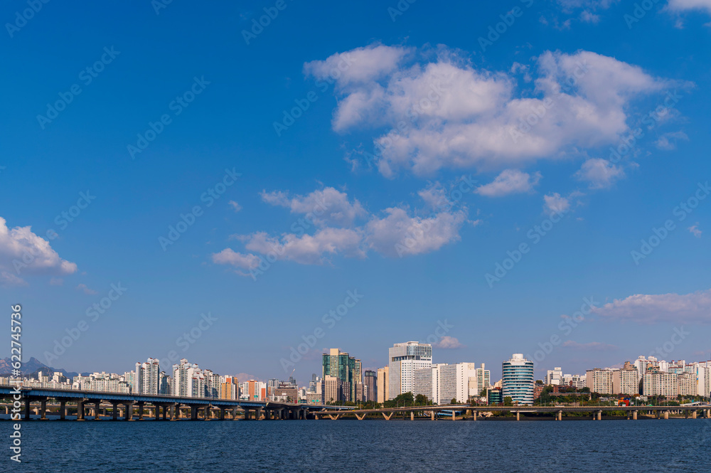 Seoul cityscapes, skyline, high rise office buildings and skyscrapers with blue sky and cloud in Seoul city, South Korea