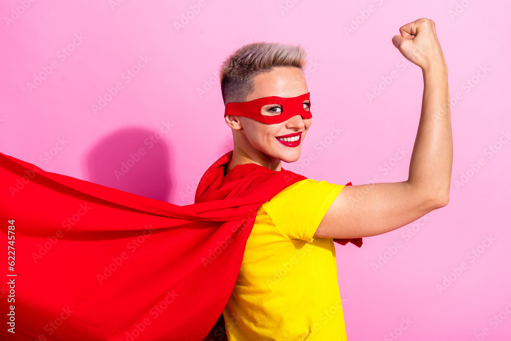 Profile photo of positive superhero lady toothy smile arm showing flexing biceps isolated on pink color background Profile photo of positive superhero lady toothy smile arm showing flexing biceps isolated on pink color background