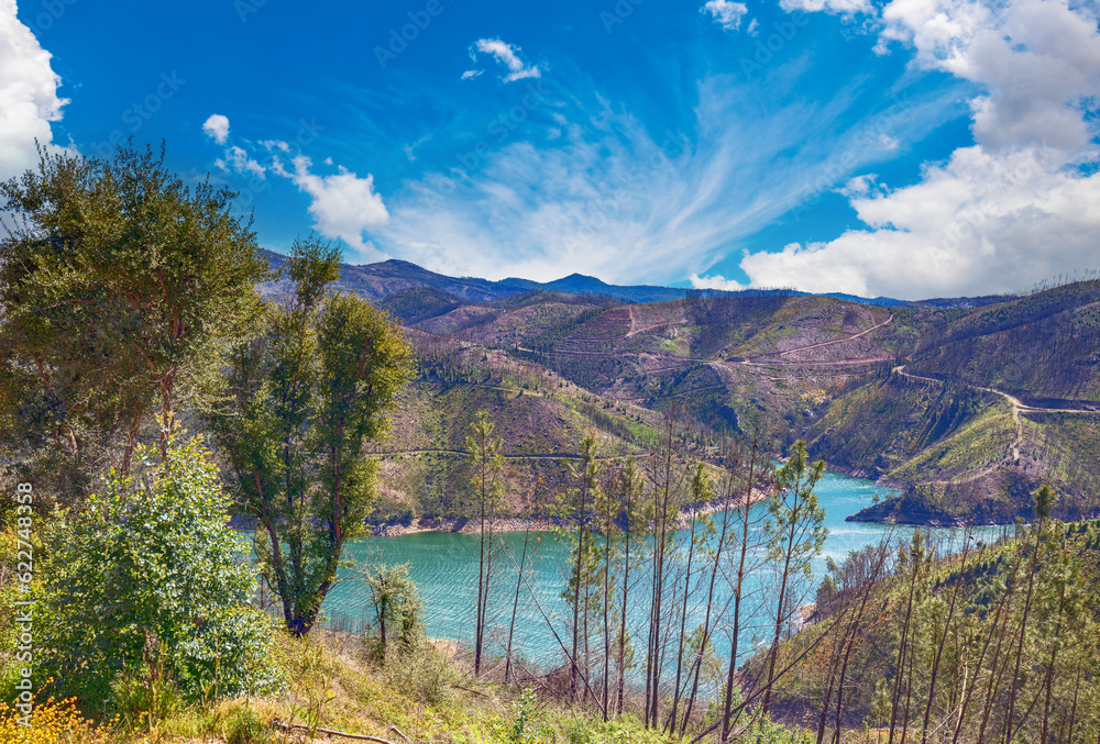 Obraz premium Mountain landscape in early spring. View of a mountain valley with a river. View of Zezere river from the mountain. Ferreira do Zezere, Portugal