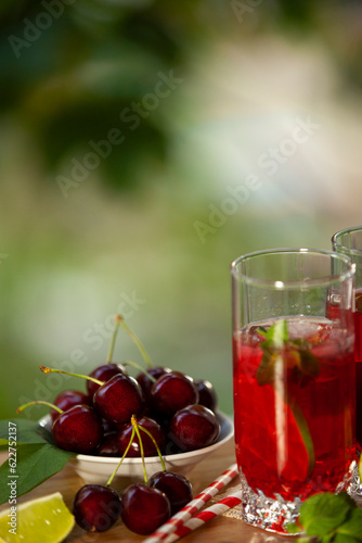 Obraz na płótnie Cherry lemonade with ice and lime in glasses. Summertime cool drink. w salonie