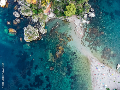 Aerial view of people on a sandy beach on Isola Bella island, Taormina, Messina, Sicily, Italy. photo