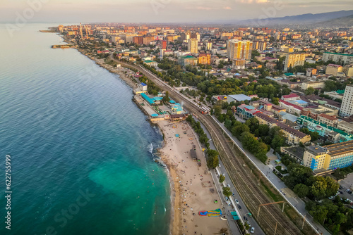 The aerial drone picture of Caspian sea beach in the city of Mahachkala, Dagestan, southern Russia with residential areas during the sunset
