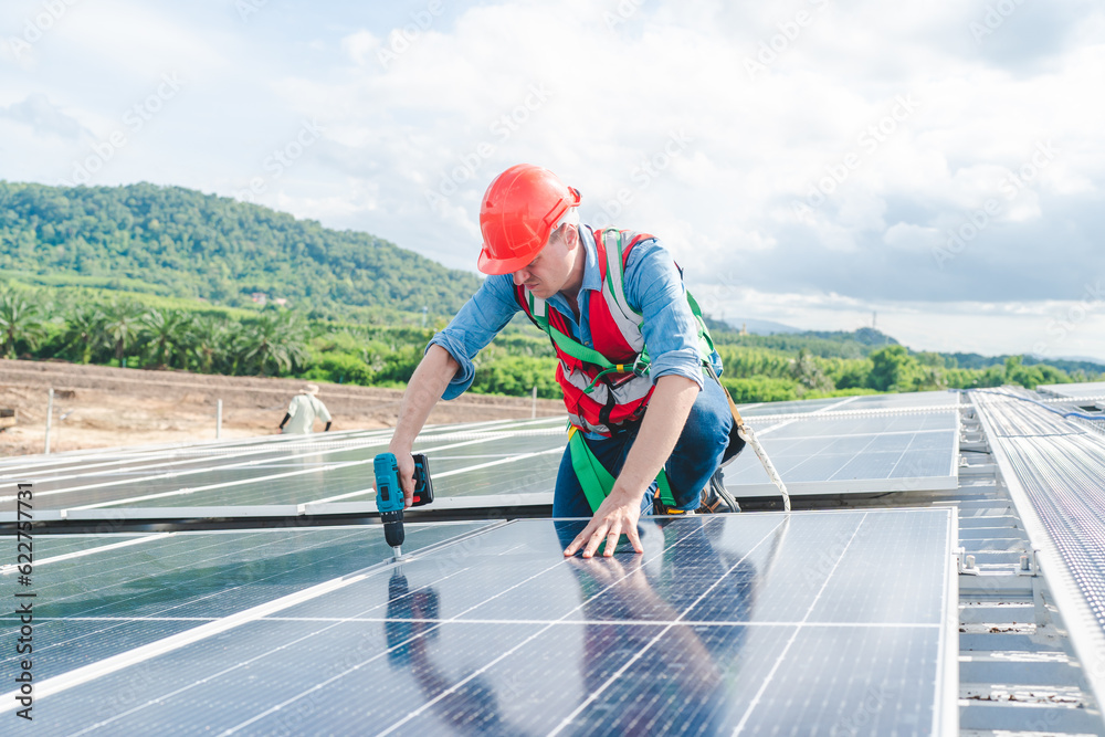 Male engineering teams install solar panels at solar power generating station, Professional engineer installing photovoltaic panel system using screwdriver, green energy and sustainable living