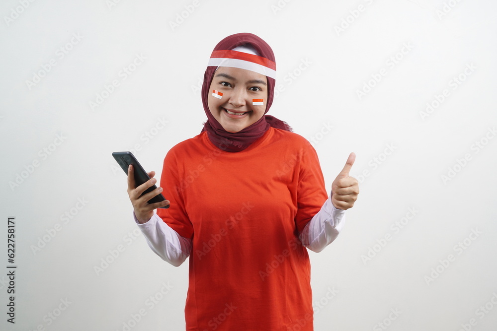Woman holding phone, okay gesture, indonesian independence day Woman holding phone, okay gesture, indonesian independence day