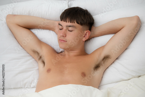 Shirtless Young Man Sleeping in Bed