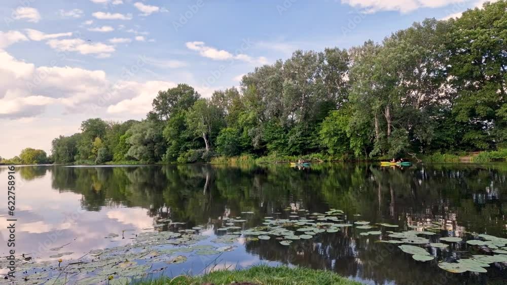 Warsaw, Poland July 11, 2023 : time lapse. Landscape of trees and river with water reflection in the Wilanow park in Warsaw. Poland Warsaw, Poland July 11, 2023 : time lapse. Landscape of trees and river with water reflection in the Wilanow park in Warsaw. Poland