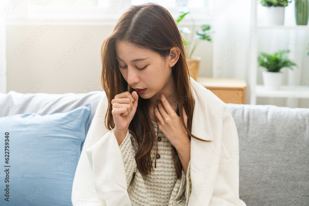 Sick, coronavirus or covid-19, illness asian young woman, girl with blanket have a fever, flu or sore throat and sneezing until chest pain while rest at home. Health care with disease, pandemic virus. Sick, coronavirus or covid-19, illness asian young woman, girl with blanket have a fever, flu or sore throat and sneezing until chest pain while rest at home. Health care with disease, pandemic virus.