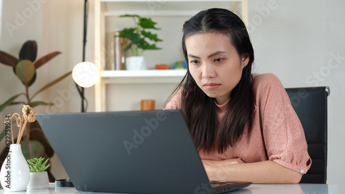 Asian women are spending their free time on vacation, doing hobbies, Watching sad tv series and movie or content on the computer with Emotions are amenable to the characters shown. Alone in the room photo