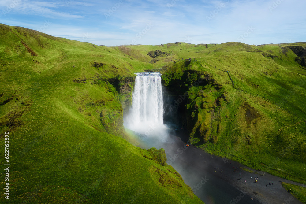 Fototapeta premium Aerial top view of Skogafoss waterfall in summer season. Famous nature landscape background
