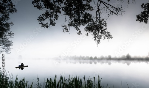 AI generated illustration of a person in a boat in a tranquil lake on a foggy day in grayscale
