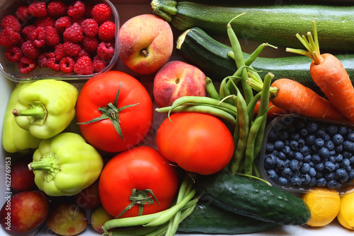 Wooden crate full of healthy colorful seasonal fruit and vegetable. Top view.