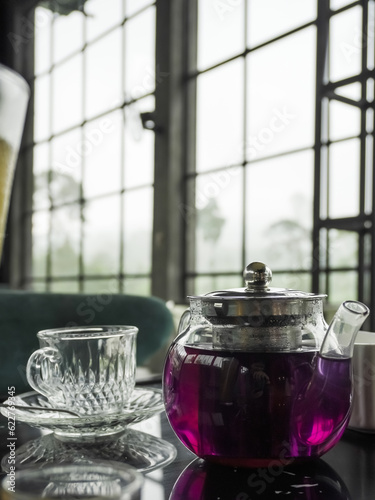 Wedhang Telang in a glass pot. Traditional drink used as herbal medicines for health, relaxation and stamina or to overcome body chills. Asian pigeonwings, bluebellvine, cordofan pea. photo