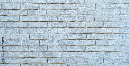 Wall made of white decorative bricks. Background, texture. Wide format, banner.
