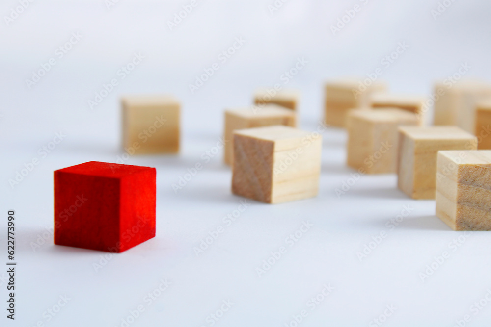 Group of wooden cubes where one is of a different color