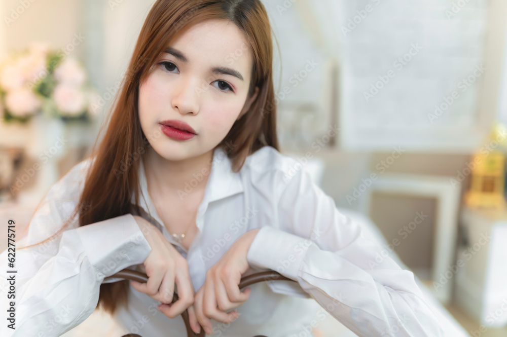 Portrait of beautiful asian woman wear white shirt in the bedroom Portrait of beautiful asian woman wear white shirt in the bedroom