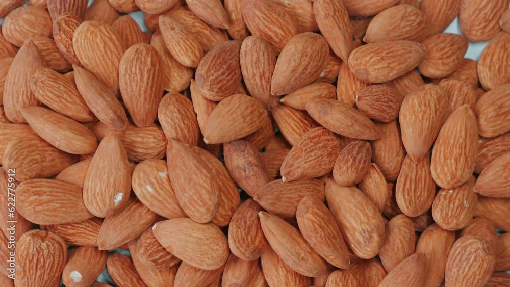 Close-up of organic, roasted almonds - a healthy and tasty snack. Concept of wholesome and nutritious food. Close-up of organic, roasted almonds - a healthy and tasty snack. Concept of wholesome and nutritious food.