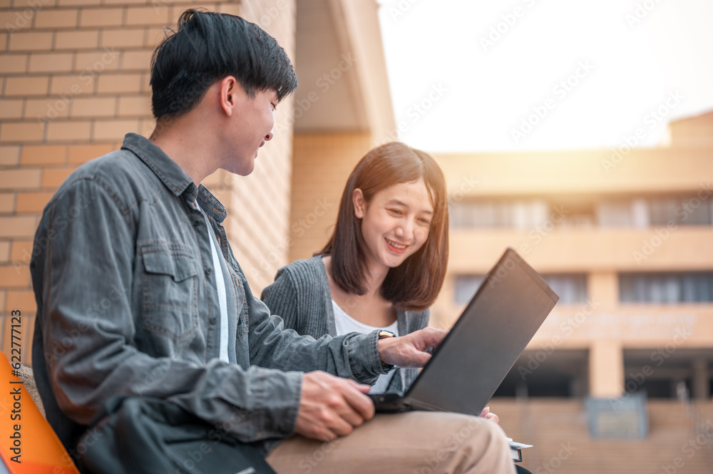 Education and Learning, Student, Campus, University, Lifestyle concept. Portrait of the two students are using laptop discussing about exam preparation, study, study for test preparation in University Education and Learning, Student, Campus, University, Lifestyle concept. Portrait of the two students are using laptop discussing about exam preparation, study, study for test preparation in University