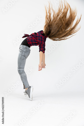 Woman forcefully throws her long hair up in the air