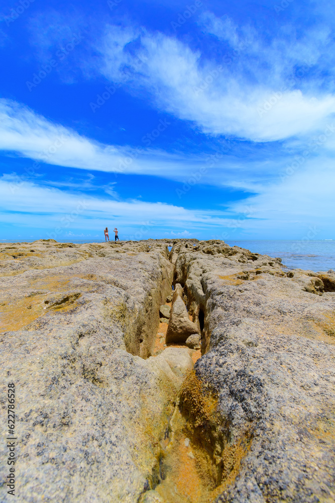 View of the reef rocks of Espelho Beach, a beautiful landscape of the coast of Porto Seguro, Bahia state, Brazil.