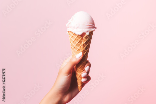 Hand holding ice cream cone on pink background. Generative AI. 