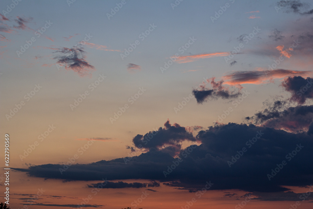 Beautiful sky with cloud. Light pink clouds in sunset blue sky. Pastel colors of clouds, sunrise sundown natural background