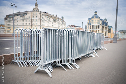 Folded portable temporary fence parts on sidewalk. Preparation for roads and sidewalk closing in case of possible protests or mass events and a large crowd of people.