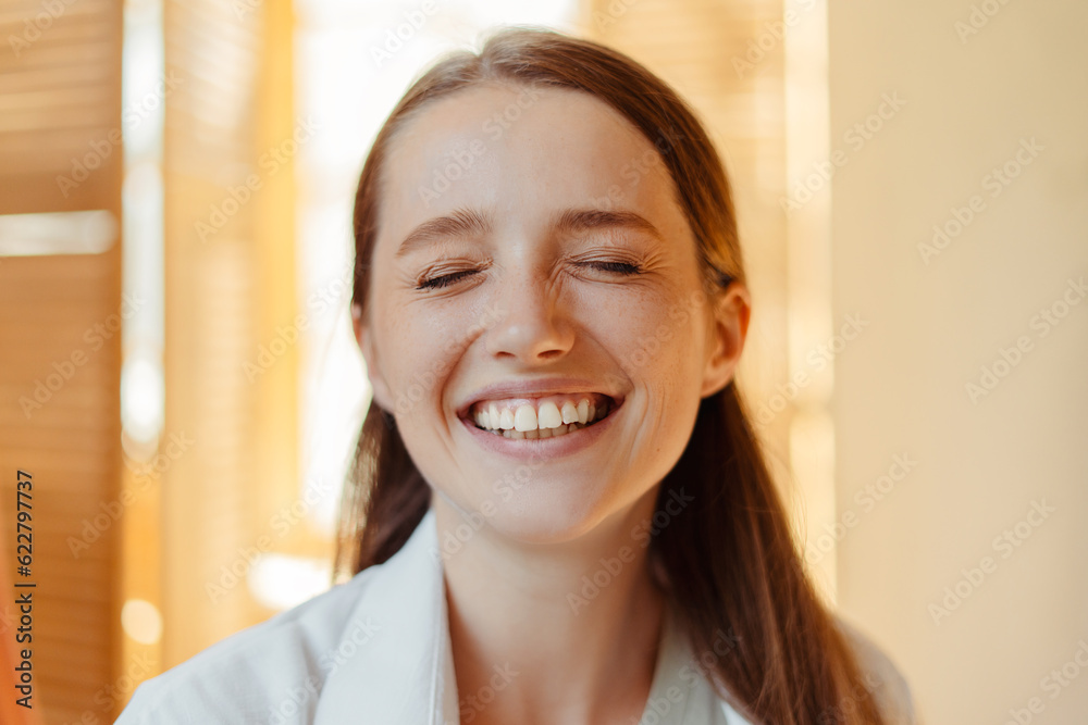 Closeup, attractive smiling woman with closed eyes indoors, concept dental care, health lifestyle