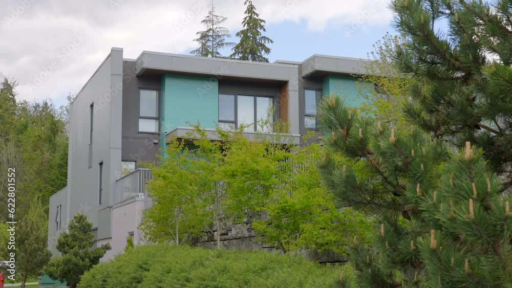 Establishing shot of modern apartment building with beautiful spring blossom landscape in Vancouver, Canada, North America. Day time on April 2023. ProRes 422 HQ. Establishing shot of modern apartment building with beautiful spring blossom landscape in Vancouver, Canada, North America. Day time on April 2023. ProRes 422 HQ.