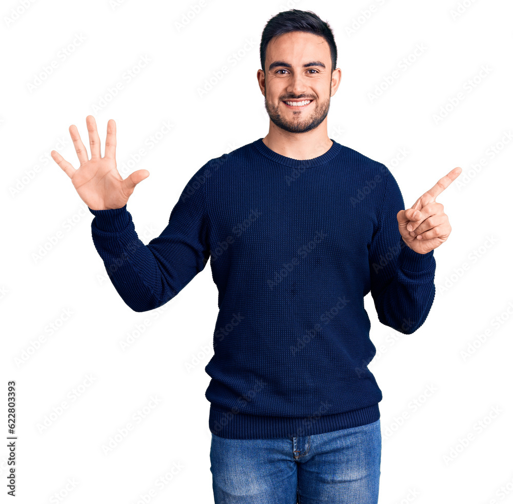 Naklejka premium Young handsome man wearing casual clothes showing and pointing up with fingers number six while smiling confident and happy.