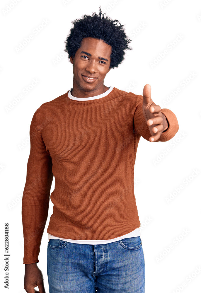 Handsome african american man with afro hair wearing casual clothes smiling friendly offering handshake as greeting and welcoming. successful business. Handsome african american man with afro hair wearing casual clothes smiling friendly offering handshake as greeting and welcoming. successful business.