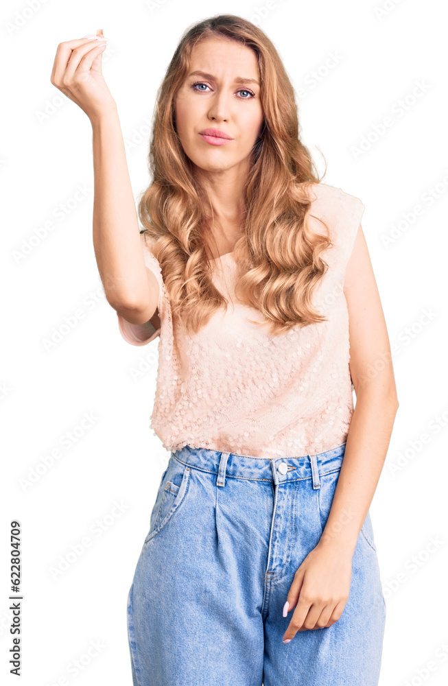 Young beautiful caucasian woman with blond hair wearing casual clothes doing italian gesture with hand and fingers confident expression Young beautiful caucasian woman with blond hair wearing casual clothes doing italian gesture with hand and fingers confident expression