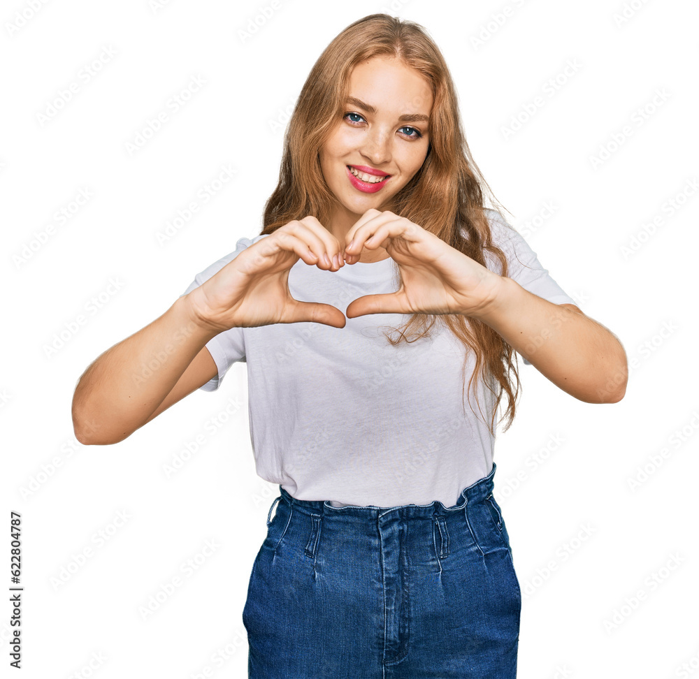 Young caucasian girl wearing casual white t shirt smiling in love showing heart symbol and shape with hands. romantic concept. Young caucasian girl wearing casual white t shirt smiling in love showing heart symbol and shape with hands. romantic concept.