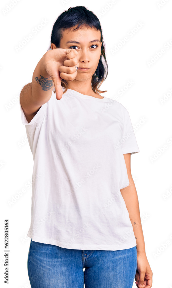 Young woman wearing casual clothes looking unhappy and angry showing rejection and negative with thumbs down gesture. bad expression. Young woman wearing casual clothes looking unhappy and angry showing rejection and negative with thumbs down gesture. bad expression.