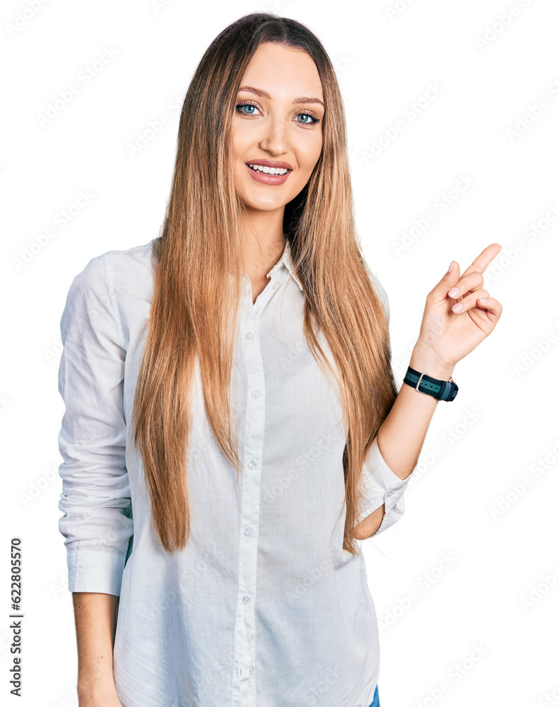 Beautiful caucasian woman wearing casual white shirt with a big smile on face, pointing with hand finger to the side looking at the camera. Beautiful caucasian woman wearing casual white shirt with a big smile on face, pointing with hand finger to the side looking at the camera.