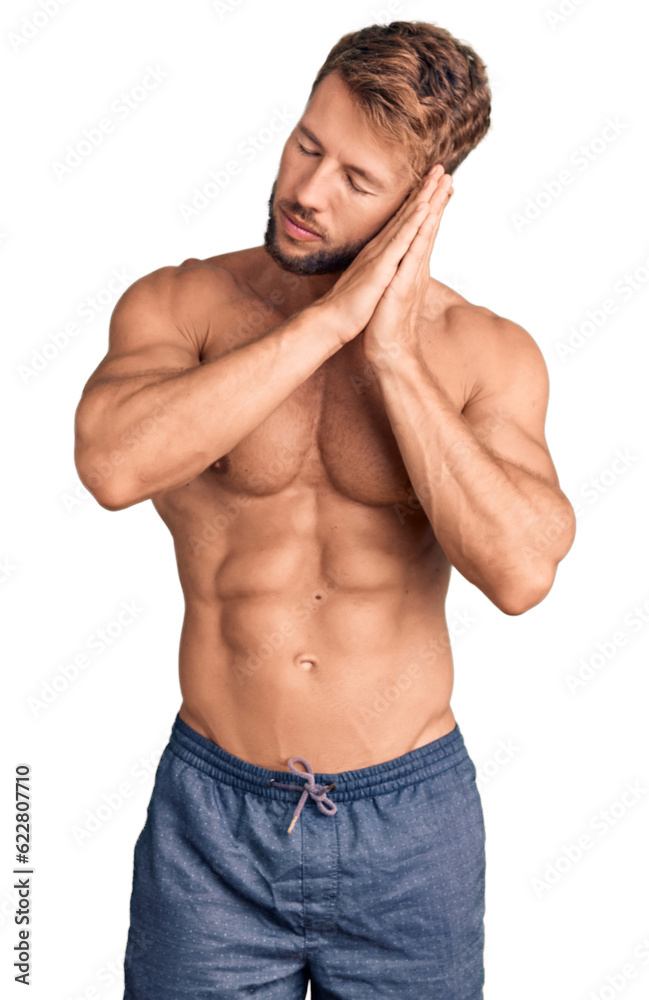 Young caucasian man standing shirtless sleeping tired dreaming and posing with hands together while smiling with closed eyes. Young caucasian man standing shirtless sleeping tired dreaming and posing with hands together while smiling with closed eyes.