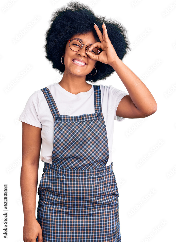 Young african american girl wearing casual clothes doing ok gesture with hand smiling, eye looking through fingers with happy face.