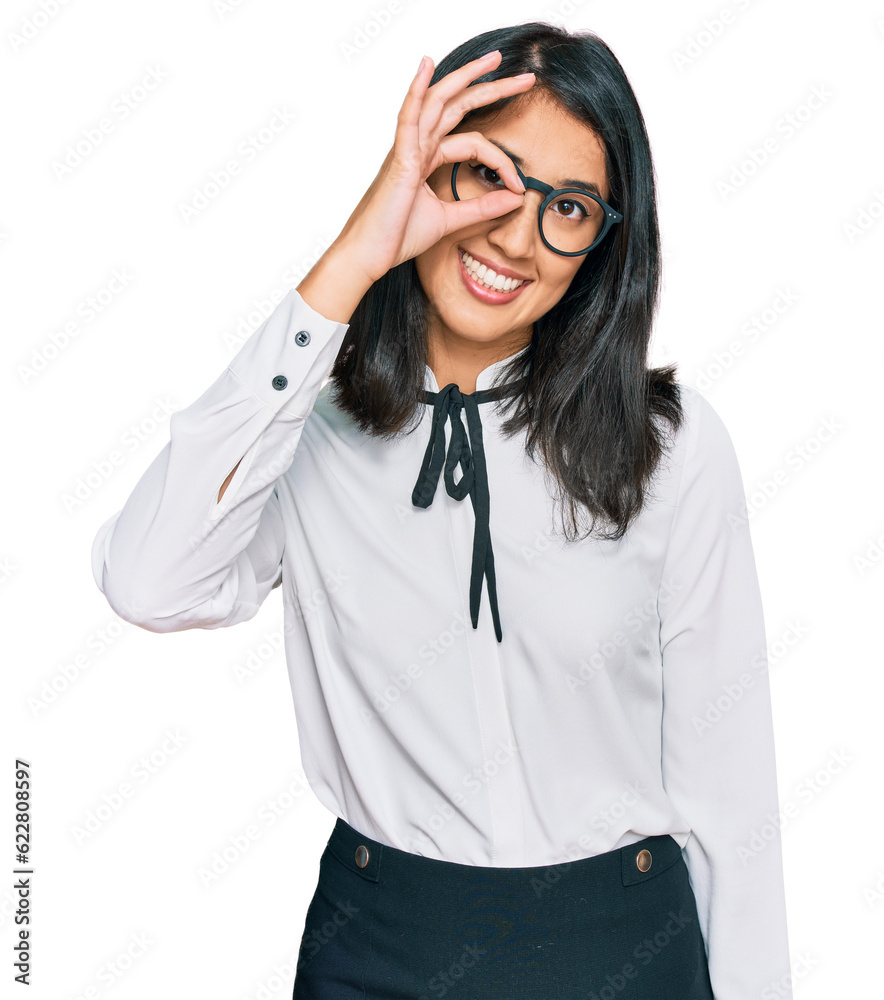 Beautiful asian young woman wearing business shirt and glasses smiling happy doing ok sign with hand on eye looking through fingers