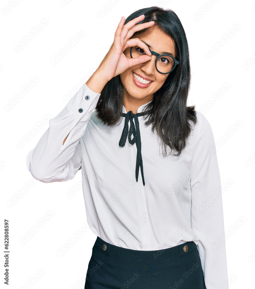 Beautiful asian young woman wearing business shirt and glasses smiling happy doing ok sign with hand on eye looking through fingers Beautiful asian young woman wearing business shirt and glasses smiling happy doing ok sign with hand on eye looking through fingers