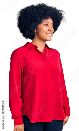 Young african american girl wearing casual clothes looking away to side with smile on face, natural expression. laughing confident.