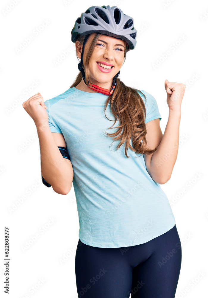 Beautiful caucasian young woman wearing bike helmet screaming proud, celebrating victory and success very excited with raised arms Beautiful caucasian young woman wearing bike helmet screaming proud, celebrating victory and success very excited with raised arms