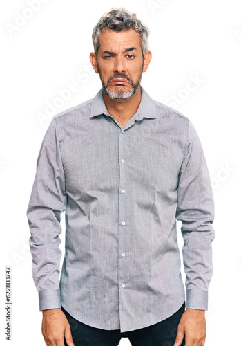 Middle age grey-haired man wearing casual clothes depressed and worry for distress, crying angry and afraid. sad expression.