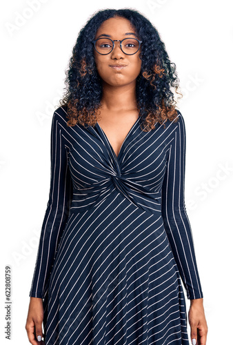 Young african american woman wearing casual clothes and glasses puffing cheeks with funny face. mouth inflated with air, crazy expression.