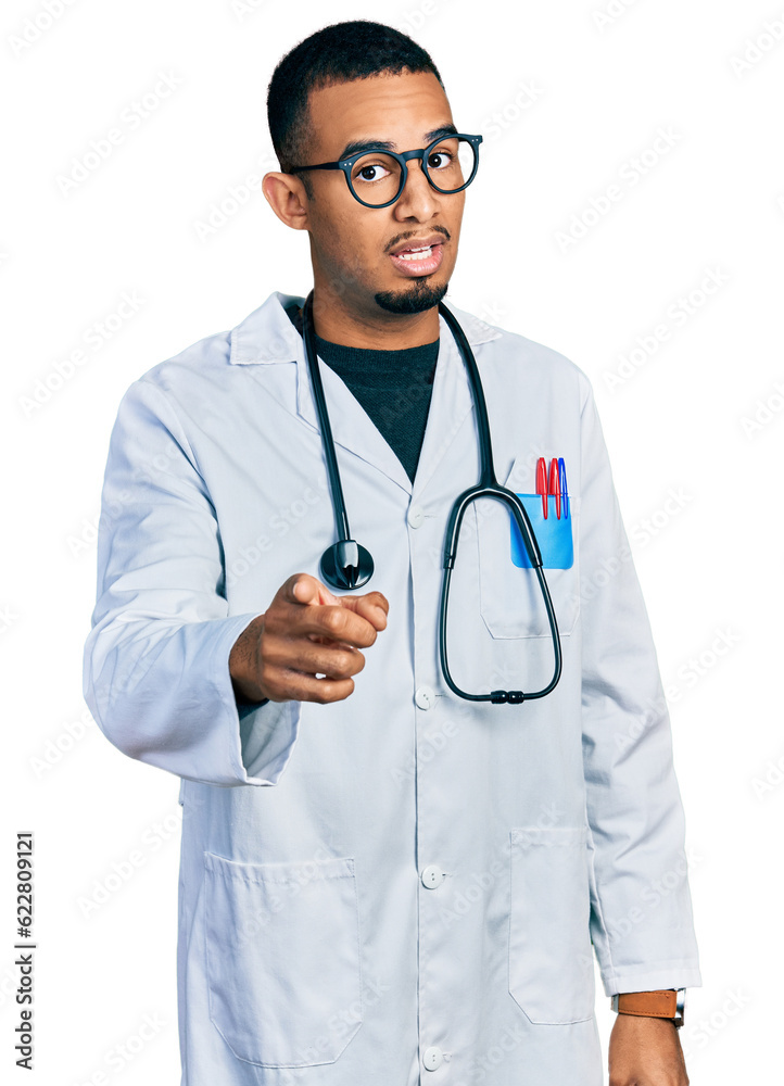 Young african american man wearing doctor uniform and stethoscope pointing displeased and frustrated to the camera, angry and furious with you Young african american man wearing doctor uniform and stethoscope pointing displeased and frustrated to the camera, angry and furious with you