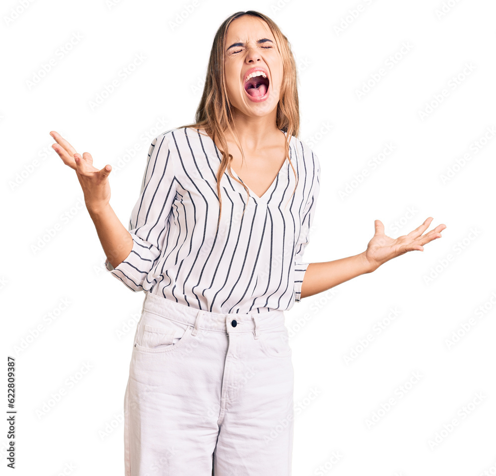 Young beautiful blonde woman wearing casual clothes crazy and mad shouting and yelling with aggressive expression and arms raised. frustration concept. Young beautiful blonde woman wearing casual clothes crazy and mad shouting and yelling with aggressive expression and arms raised. frustration concept.